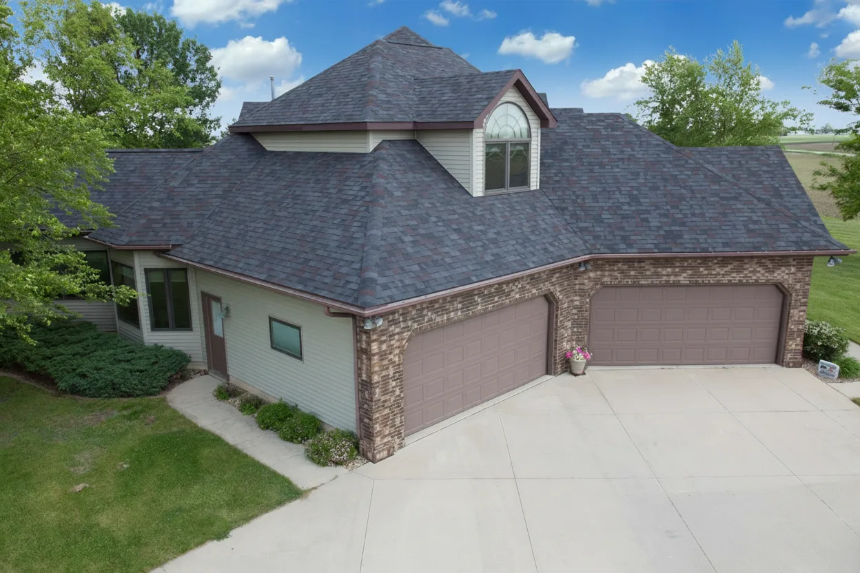 Beige house with Charcoal roof using Vista Black Oak