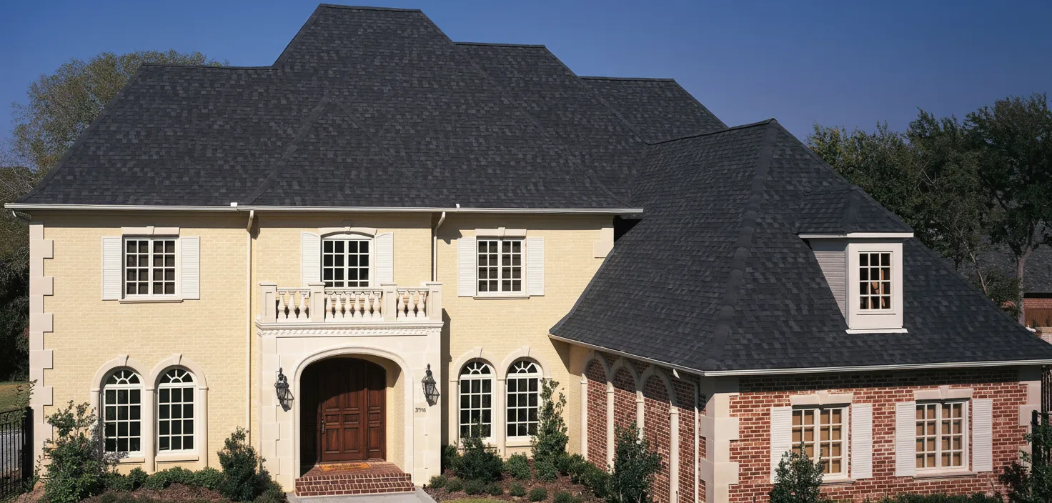 Yellow house with Black roof using Heritage Rustic Black