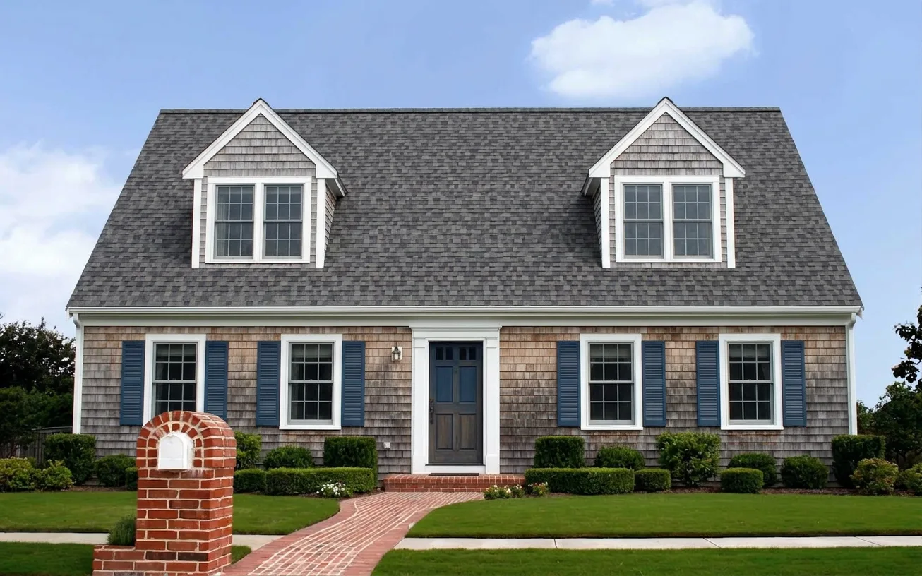 Cape Cod home with Charcoal roof -- Owens Corning Duration Midnight Plum (front)
